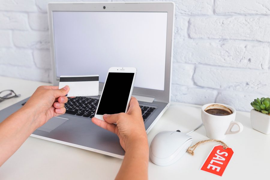 A smartphone with a loan app on one side and a stack of bills on the other
