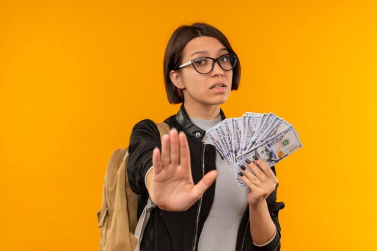 Recent college graduate reviewing income-share agreement terms on laptop