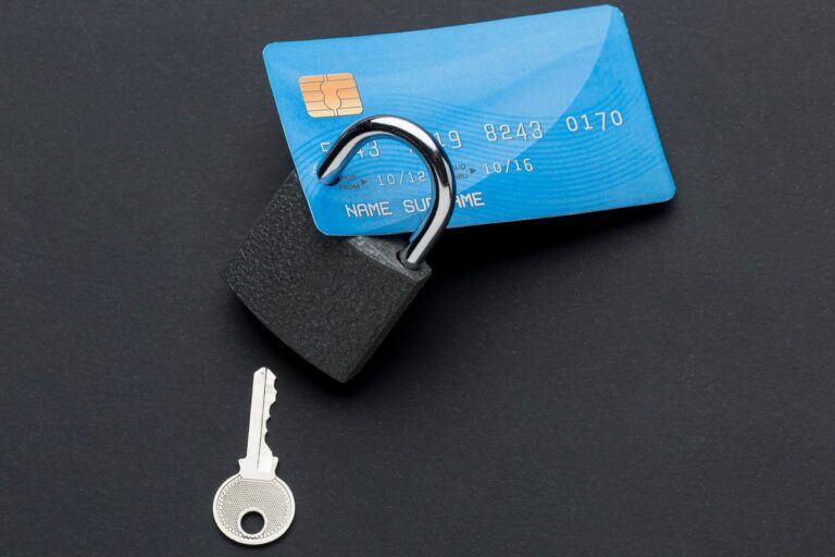 Single parent in Detroit holding credit card with 740 credit score achievement displayed