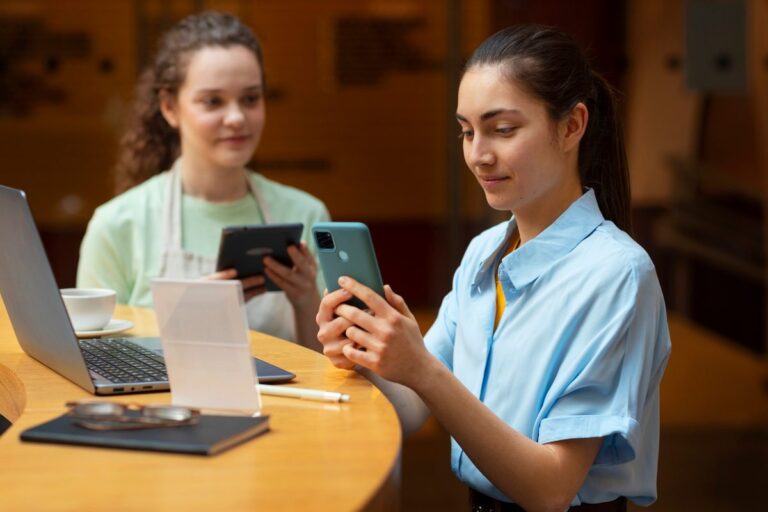 Nursing student in scrubs reviewing digital loan options on laptop for clinical year expenses