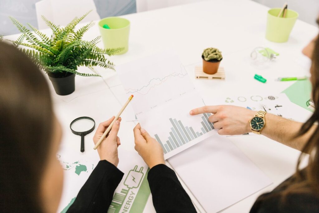 Person reviewing ESG investment portfolio on laptop with financial charts