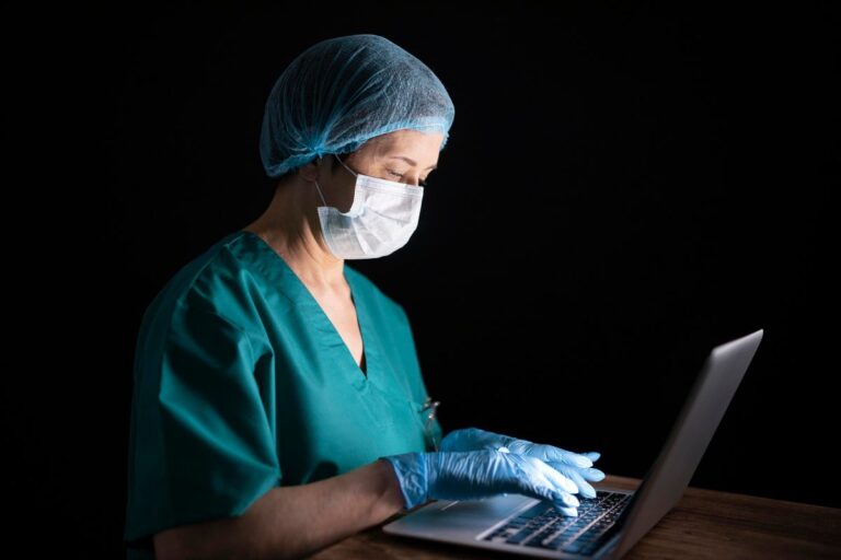 Night-shift nurse reviewing fintech savings app on mobile phone during break