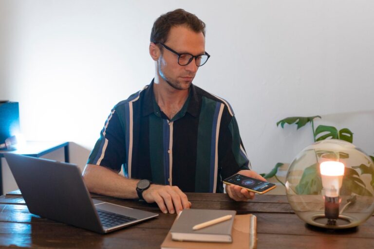 Gig worker reviewing fintech loan options on phone with income verification documents