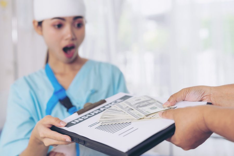 Healthcare worker reviewing mortgage documents with a stethoscope nearby