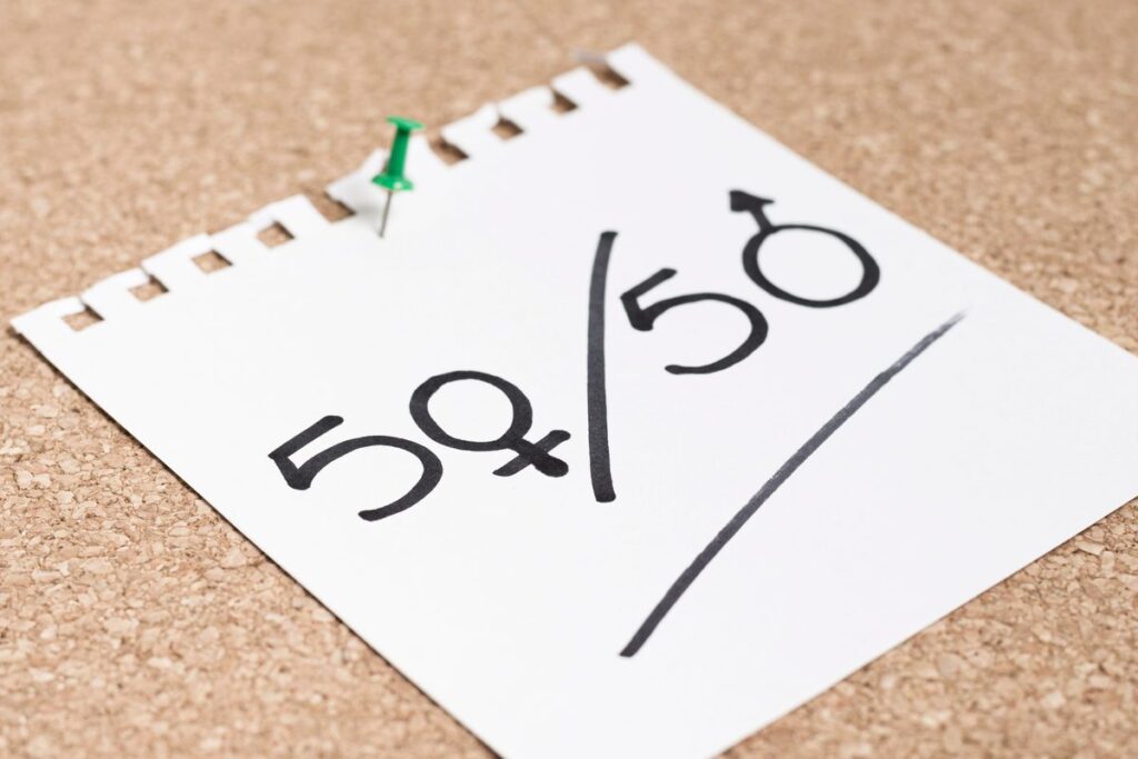 Single parent at home reviewing debt management plan documents and budget paperwork