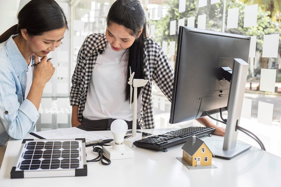 Homeowner comparing solar loan offers on a tablet with utility bill and roof plan visible