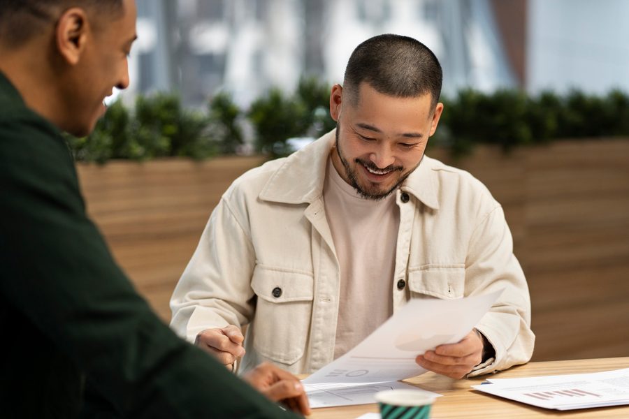 Self-employed borrower reviewing tax documents and mortgage paperwork at a home office desk